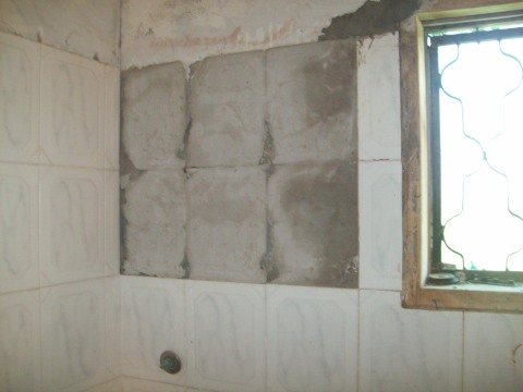 Tiles off the bathroom wall due to close shelling